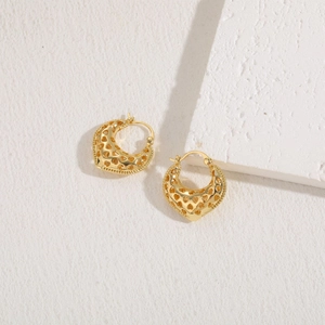 Detail of 14K gold plated earrings featuring hollow heart patterns and crescent design