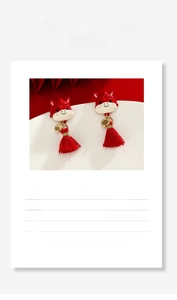 Detail view of red enamel horse earrings with 925 silver needle and gold tassels