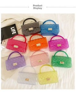 Flat lay of colorful jelly bags with quilted patterns, beaded handles and gold locks