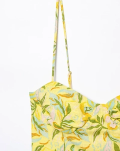 Detail of adjustable straps and floral linen blend texture on the yellow summer top