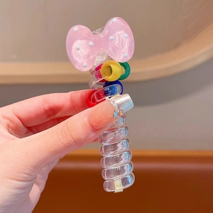 Pink polka dot bow hair clip with colorful spiral resin handle for stylish ponytails