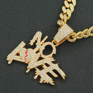 Iced out gold Cuban chain with NO LOVE heart pendant and sparkling rhinestones