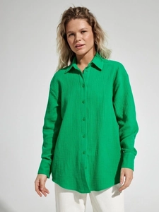 Detail view of long-sleeve cotton crepe shirt showing vibrant green crinkle fabric texture