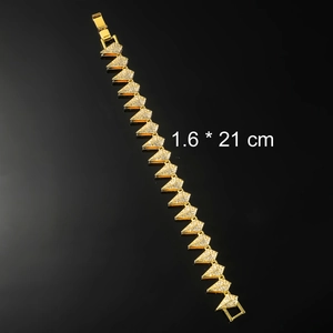 Macro shot of gold-plated geometric link chain with pave crystals and 1.6 x 21 cm scale mark