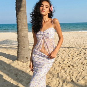 Detail of floral two-piece set with a crop top and slim skirt on a sunny beach