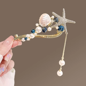 Détail de l'épingle à cheveux avec coquillage rose, cristaux et pampilles de perles