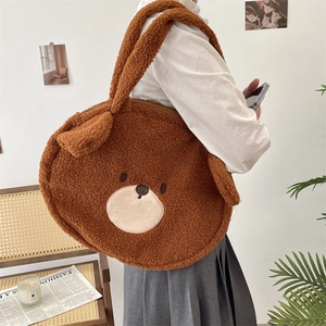 Detail of cute teddy bear plush tote bag showing soft brown faux fur and embroidery