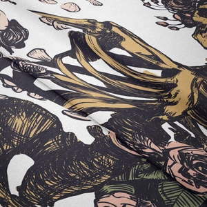 Close-up of woven fabric texture with intricate black and gold floral sketches