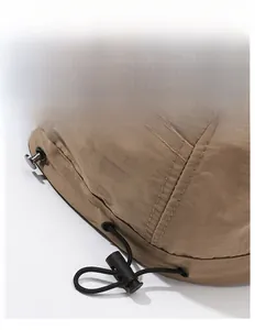 Detail of adjustable elastic drawstring and toggle on khaki sun hat for customized fit