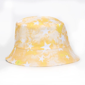 Detail of yellow tie-dye bucket hat featuring white star patterns on durable cotton fabric