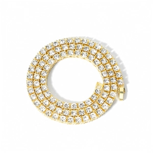 Detail of 4mm single row gold tennis chain featuring round cut clear zircon stones