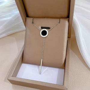 Detail of geometric planet necklace with Roman numerals pendant in a premium gift box