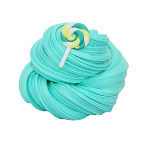 Detail of teal fluffy slime texture decorated with a colorful rainbow swirl lollipop