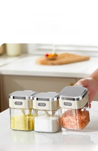 Three-piece kitchen seasoning jars with transparent glass and cream-colored flip lids