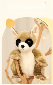 Macro shot of realistic plush lemur doll with soft brown fur resting on a tree branch