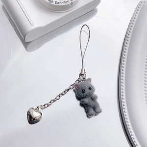 Detail of grey flocked kitten and silver heart pendant on a y2k style keychain