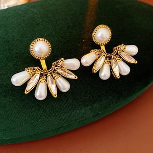 Detailed view of vintage gold fan-shaped drop earrings with pearls and marquise crystals