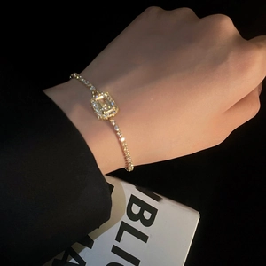 Elegant gold bracelet featuring yellow emerald-cut zircon and pave crystals on wrist