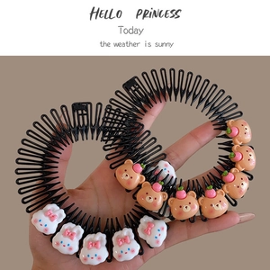 Close-up of kids hair combs with cute white rabbit and brown bear cartoon ornaments