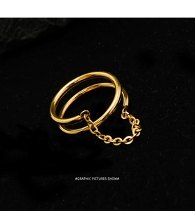 Macro view of minimalist double-layer gold chain ring with a polished metal finish