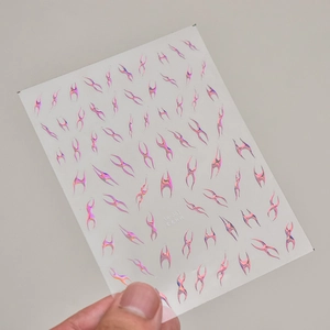Macro shot of silver flame nail stickers featuring laser holographic abstract designs