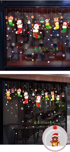 Christmas window decals showing festive Santa, reindeer and snowman on a coffee shop glass