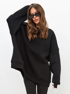 Detail of black oversized crewneck sweatshirt featuring drop shoulder seams and ribbed cuffs