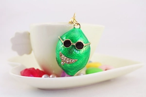 Dettaglio del portachiavi a forma di limone verde con occhiali e strass lucidi