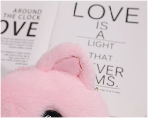 Detail of pink plush crossbody bag showing soft faux fur texture and embroidered kitten ears
