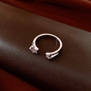 Macro view of adjustable star ring with pavé-set zircons on dark leather texture