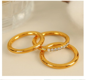 Close-up of set of three gold stackable rings including one pave-set eternity band