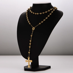 Gold stainless steel catholic rosary necklace with beads and crucifix on black display