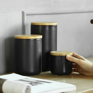 Three-piece black ceramic storage jars set with wooden lids for coffee or tea
