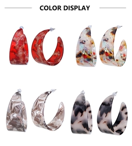 Detail view of acetate C-shaped earrings in red, floral, coffee, and tortoiseshell patterns