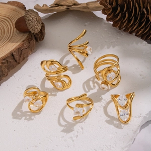 Close-up of 18K gold plated stainless steel rings with sparkling cubic zirconia on wood