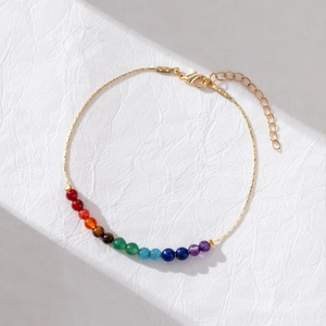 Rainbow gemstone 14K gold-plated beaded bracelet with lobster clasp on white leather