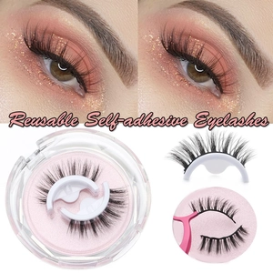 Reusable self-adhesive black eyelashes in pink case with application tool detail