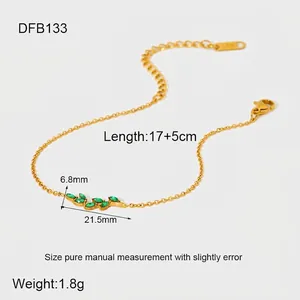 Detail of 18K gold-plated stainless steel bracelet with green zircon leaf charm