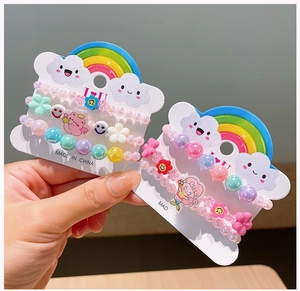 Detail of colorful acrylic beaded bracelets for girls with flower and animal charms