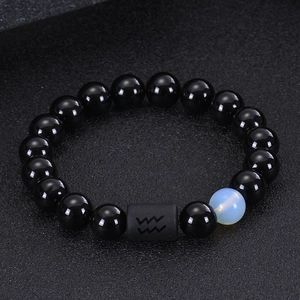 Macro detail of Aquarius beaded bracelet with black agate, tiger eye and blue gemstone