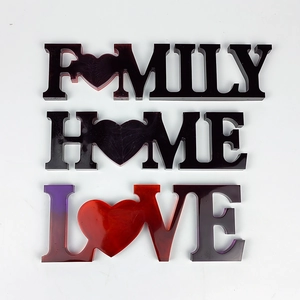 Detail of HOME FAMILY LOVE resin craft letters with purple and red gradient gloss