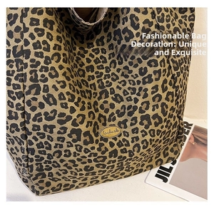 Close-up of leopard print tote bag with handmade metal plaque and stylish texture