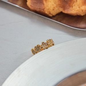 Detailed macro view of 18K gold plated floral ring band with sparkling zircon stones