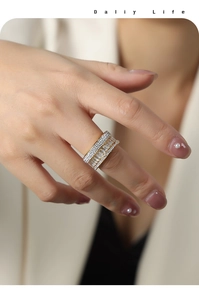 Close-up of three-row gold-plated baguette and round cut zircon encrusted ring