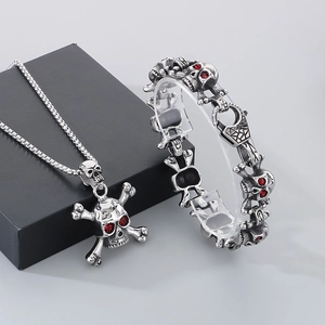 Dark gothic skull jewelry set with red crystal eyes including necklace and bracelet