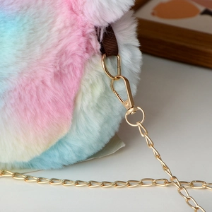 Detailed close-up of the plush rainbow faux fur bag with a golden metal chain clasp