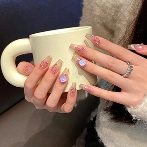 Pink blush cat-eye press-on nails with glitter and 3D rhinestones on long coffin shape