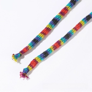 Macro detail of rainbow striped knitted drawstrings showing colorful woven yarn texture