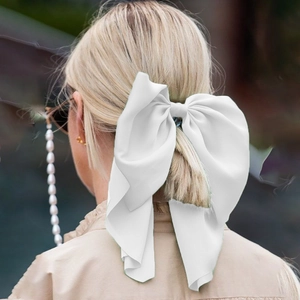 Detailed back view of a large white silk tulle bow hairclip with long flowing streamers