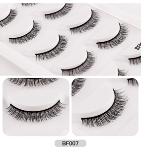Macro detail of thick and long synthetic fiber false eyelashes in a multi-pack set